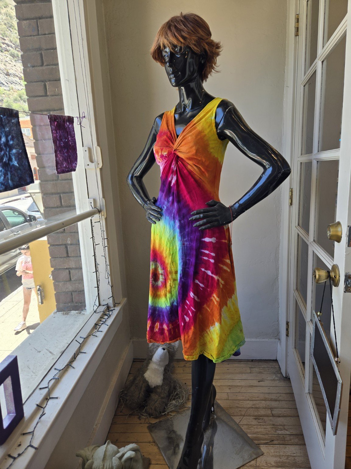 Rainbow tie-dye dress displayed on a mannequin