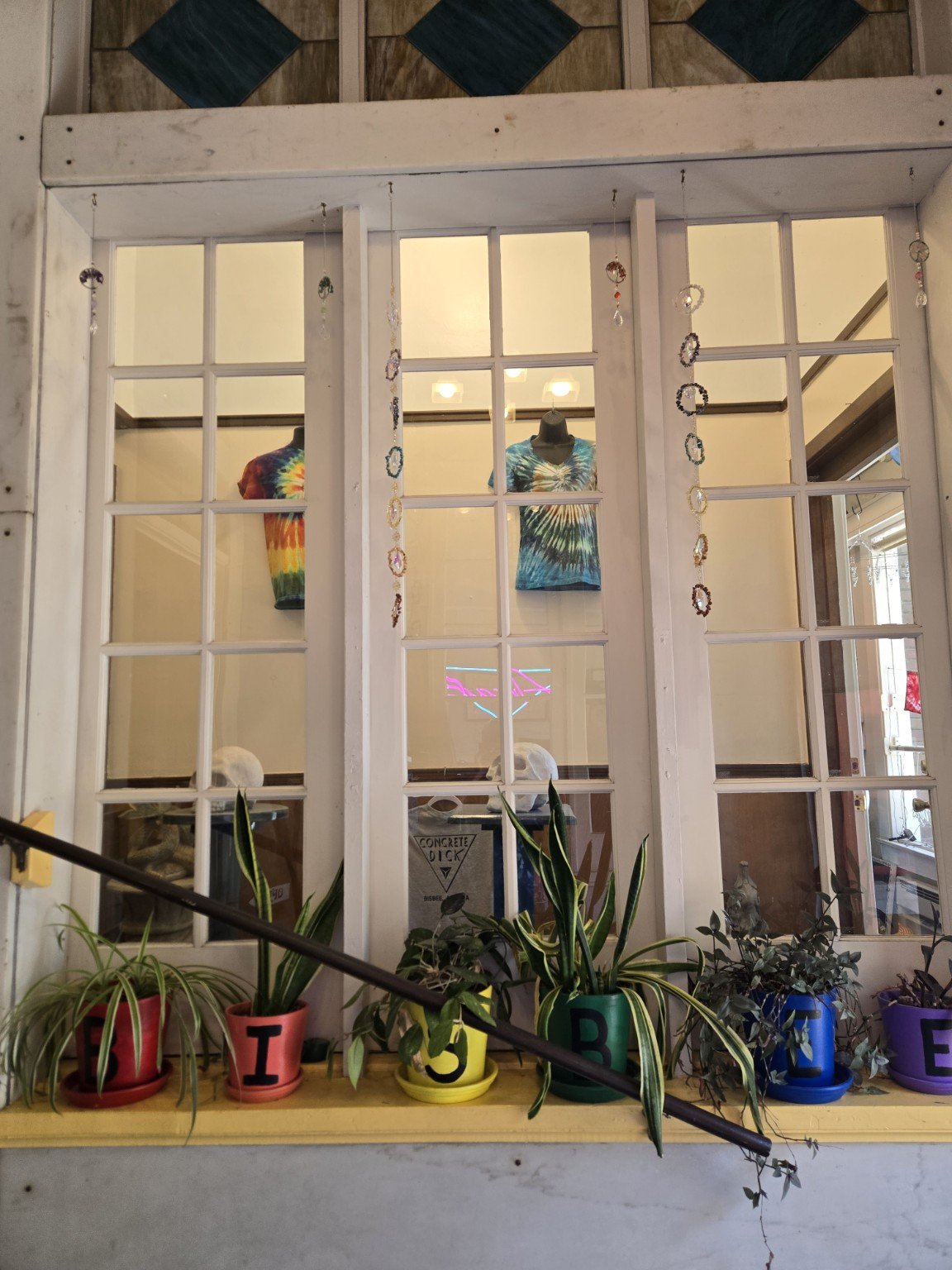 Entrance to Doc’s Dyes with colorful clothing visible inside