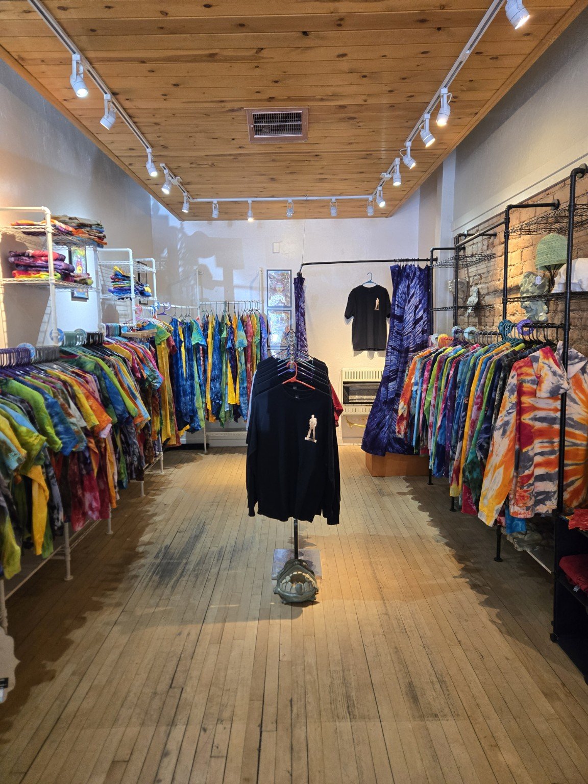 Inside Doc’s Dyes with racks of colorful hand-dyed clothing